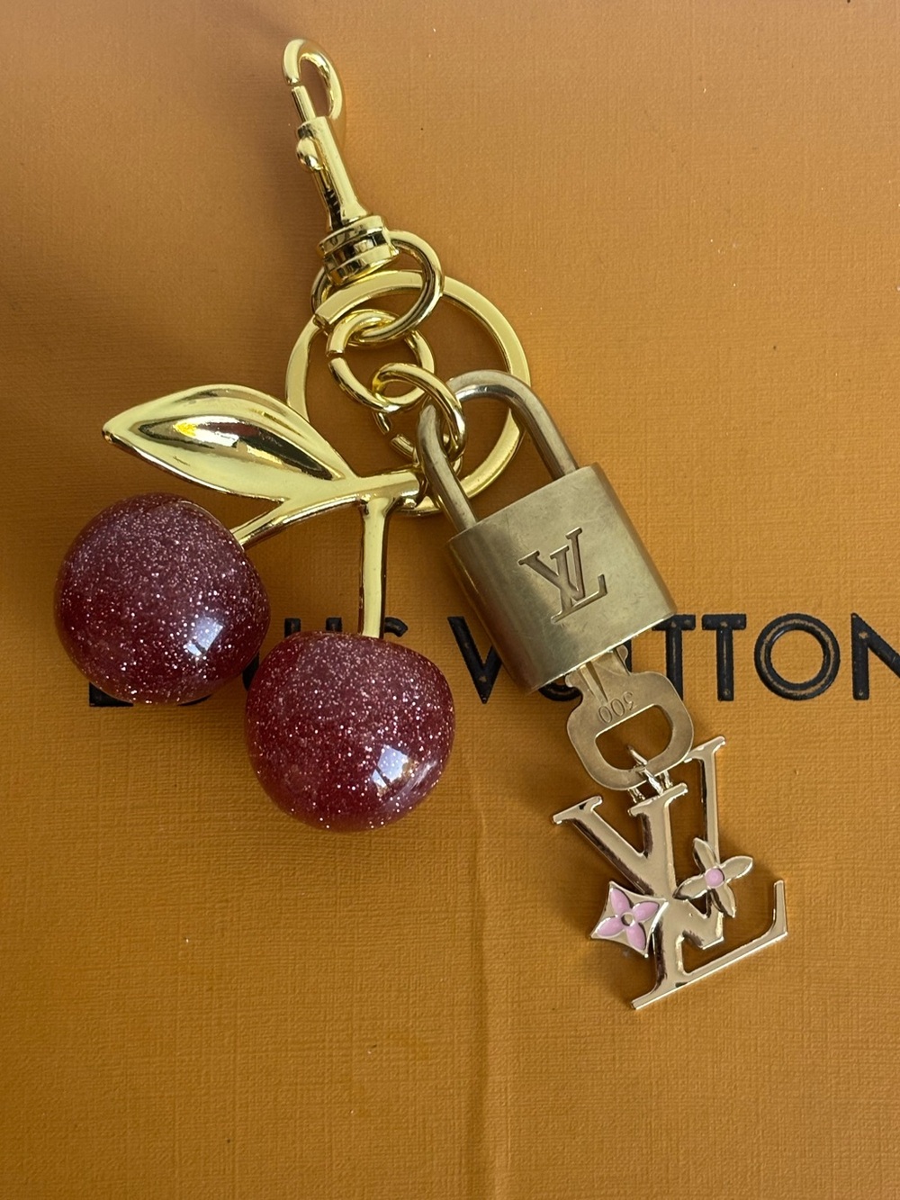 AUTHENTIC LOUIS VUITTON
BRASS LOCK AND KEY #300, PINK CHERRY BAG CHARM, 5.5 IN.
